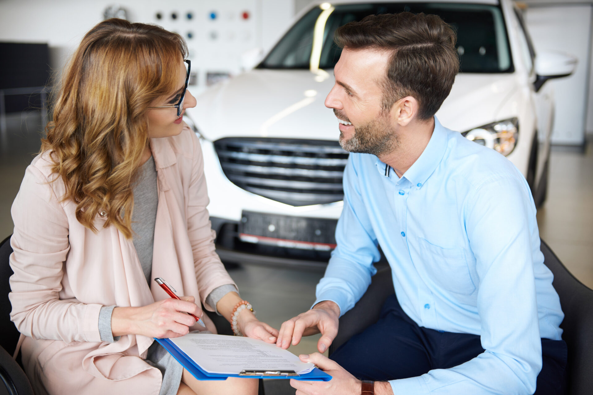 A vibrant image showcasing diverse individuals discussing car rental insurance in Dubai, symbolizing informed decision-making and customer interaction.