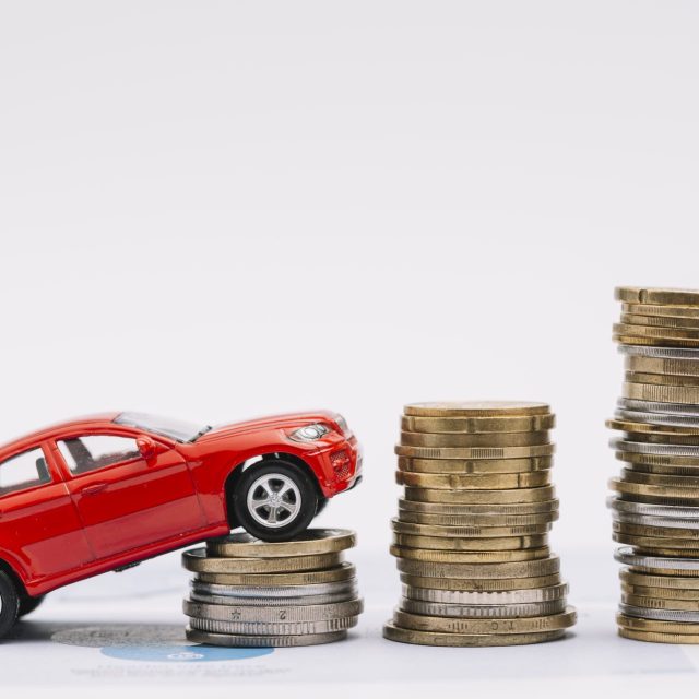 Conceptual image showing a toy car ascending a stack of coins, symbolizing how to save money on car rentals in Dubai